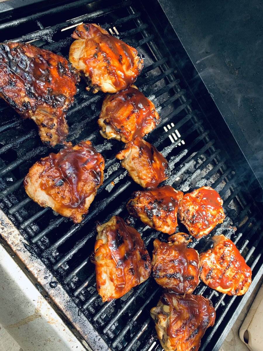 Barbecue chicken thighs on the gas grill, 2024 — photograph by Ray Patrick
