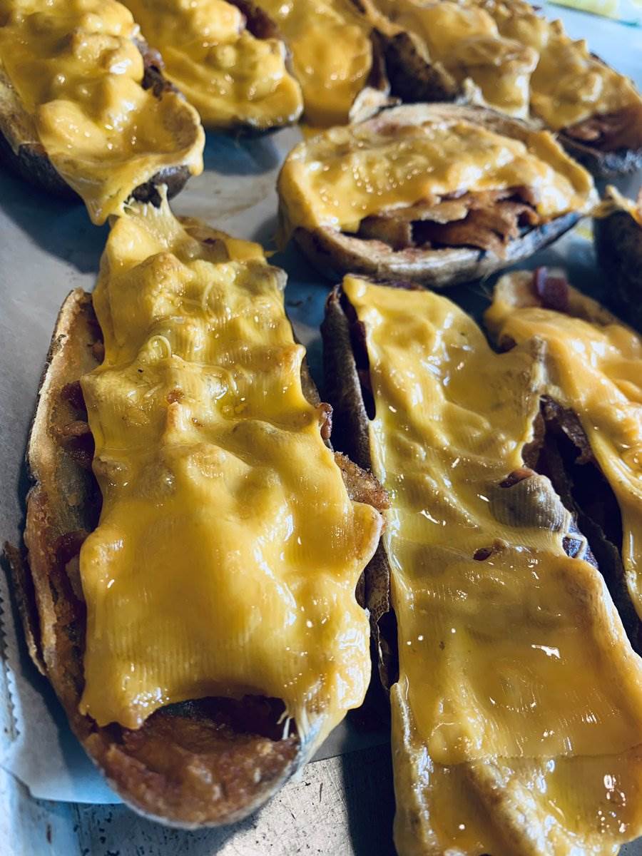 Cheddar melting over bacon-filled potato skins, 2025 — photograph by Ray Patrick
