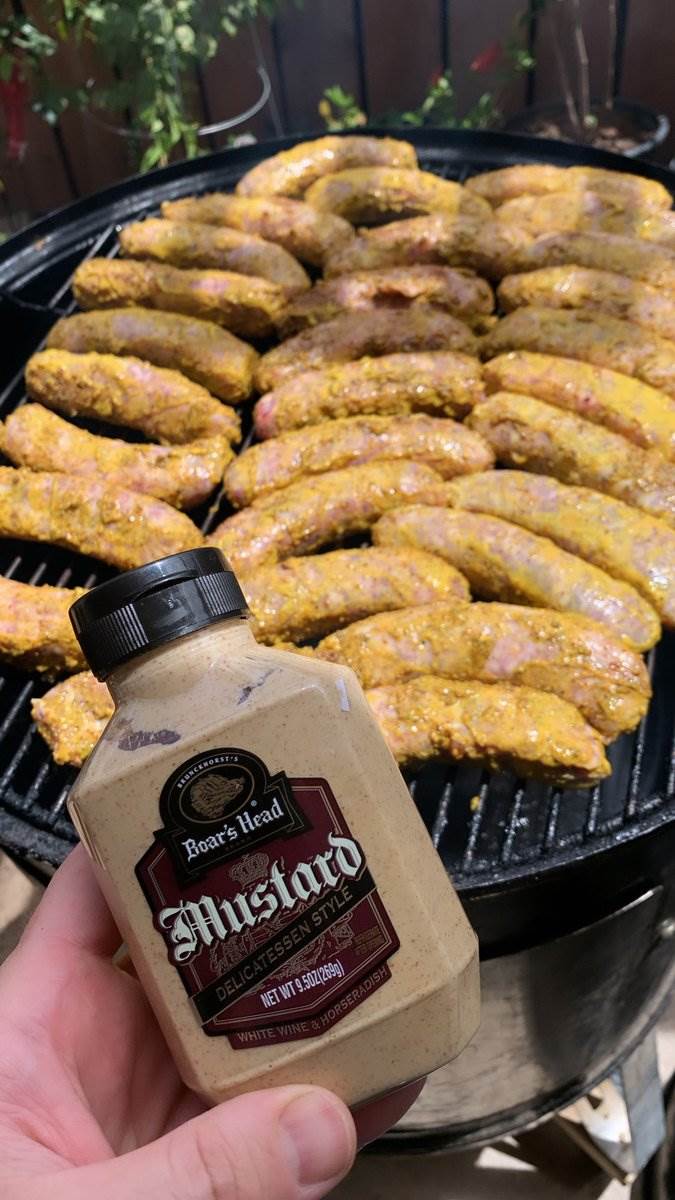 Mustard-slathered bratwursts filling the grill, 2024 — photograph by Ray Patrick