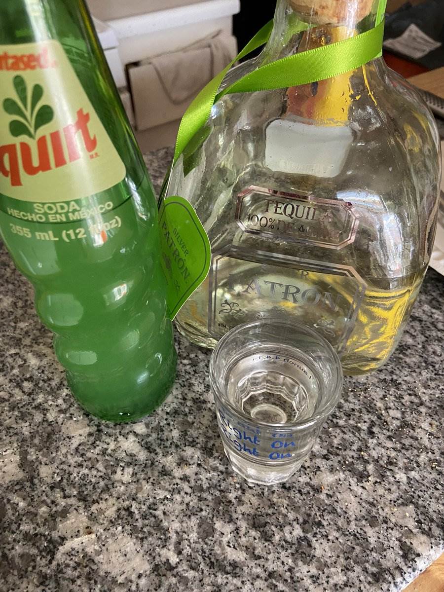 Patrón, Squirt and a shot glass on the counter, 2024 — photograph by Ray Patrick
